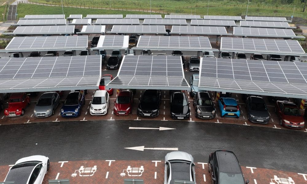 There's more than just cars and empty spaces in this car park. Huge arrays of angled solar panels sit atop jet black steel supports, soaking up the sun and shading the vehicles beneath.